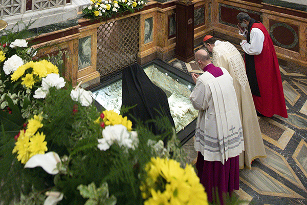 Romanian Orthodox Bishop Atanasie Rusnac, vicar for the Diocese of Italy, Cardinal Kurt Koch, president of the Pontifical Council for Promoting Christian Unity, and Anglican Archbishop Ian Ernest, director of the Anglican Centre in Rome, pray at the tomb of St. Paul during vespers to close the Week of Prayer for Christian Unity, at the Basilica of St. Paul Outside the Walls in Rome Jan. 25, 2021. (CNS photo/Vatican Media)