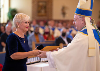 Meryl Cerana, Pastoral Associate/Business Manager at Mary, Mother of Mercy Parish in Glassboro, receives the Bishop's Medal from Bishop Dennis Sullivan on Oct. 17 in Blackwood's Our Lady of Hope Parish,