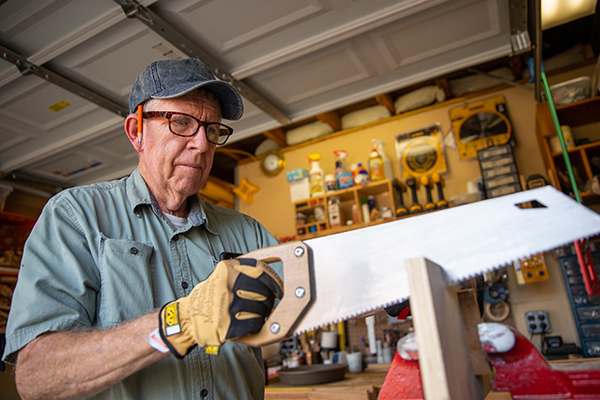Fr. Mike Coffey cuts wood to construct a birdhouse, in his woodworking shop at Holy Eucharist Parish in Cherry Hill, NJ on Monday, October 25, 2021.
