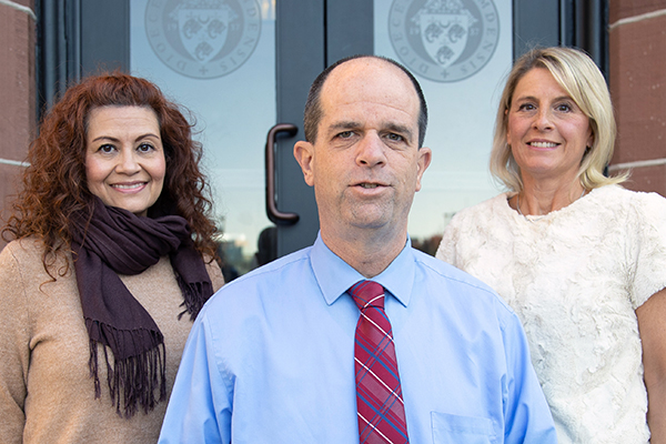 Rubi Lukasiewicz, left, Kevin Drum, and Tami Wallace stand in front of newly installed doors at the Cathedral of Immaculate Conception in Camden, NJ on Wednesday, November 3, 2021.