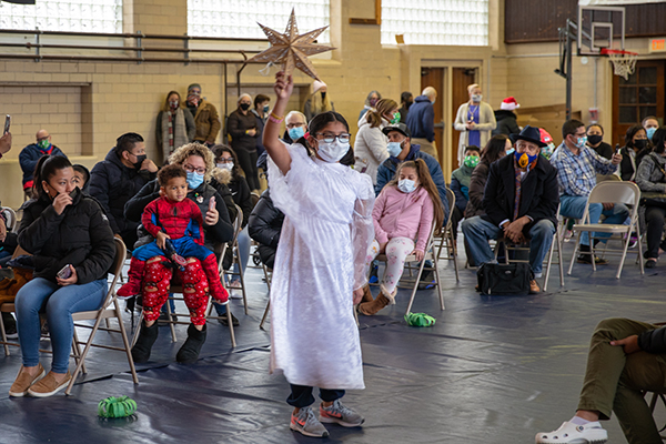 An angel makes her way to the stage during the live nativity pageant at Our Lady Star of the Sea Parish in Atlantic City, NJ on Saturday, December 18, 2021.