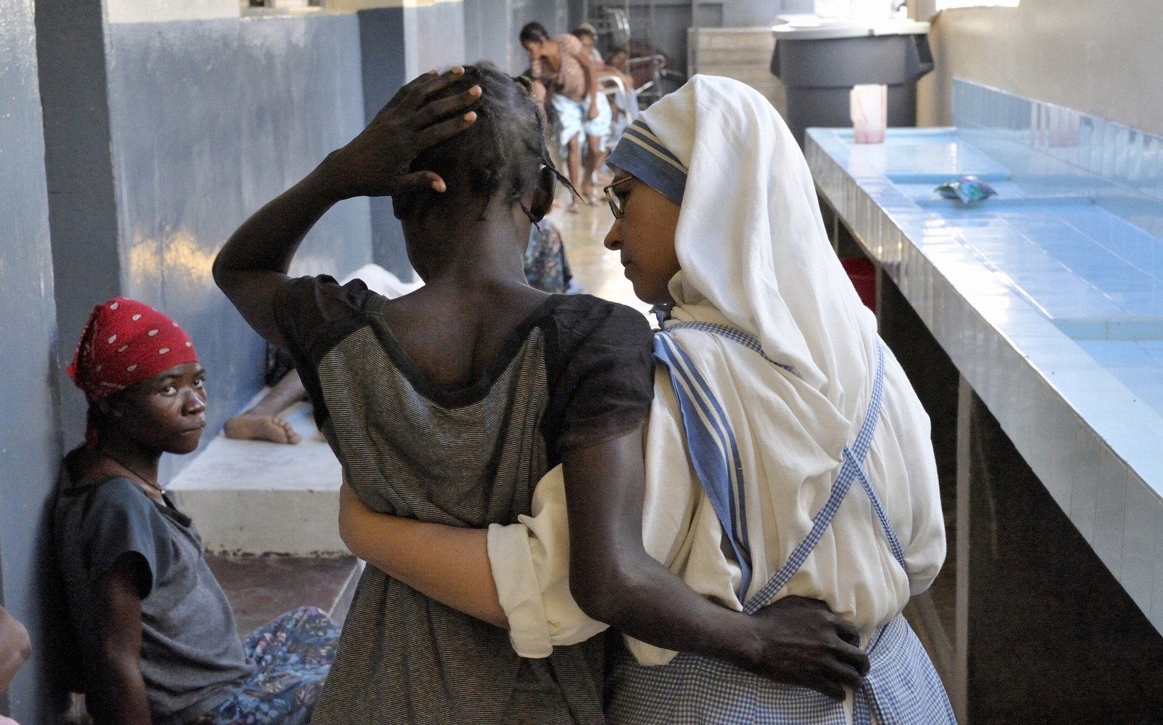 Spanish Missionary of Charity Sister Paul supports a patient at the House for the Dying in Port-au-Prince, Haiti, in this Oct. 16, 2009, file photo. The Vatican released Pope Francis' message for World Mission Sunday, which will be celebrated Oct. 23 with the theme, "You shall be my witnesses." (CNS photo/Paul Jeffrey)