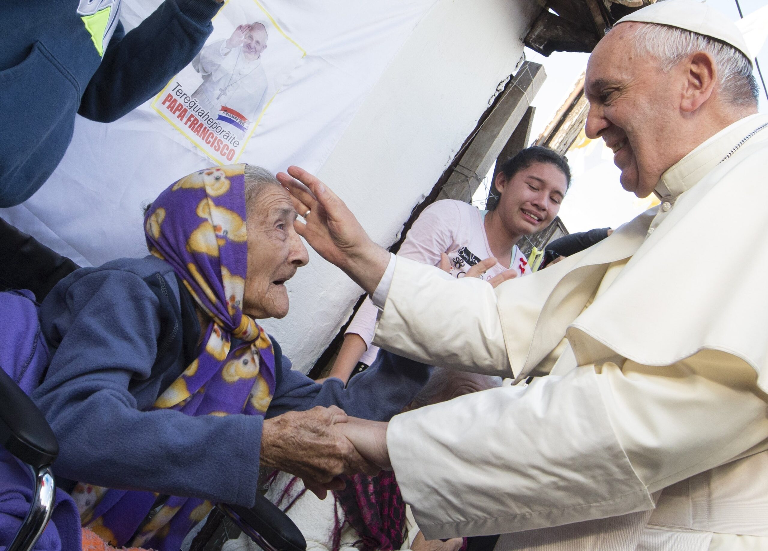 Pope Francis greets an elderly woman as he meets with people in Asuncion, Paraguay, in this July 12, 2015, file photo. The pope has chosen the theme, "In old age they will still bear fruit" (Psalm 92:15), for the second World Day for Grandparents and the Elderly July 24. (CNS photo/Paul Haring)
