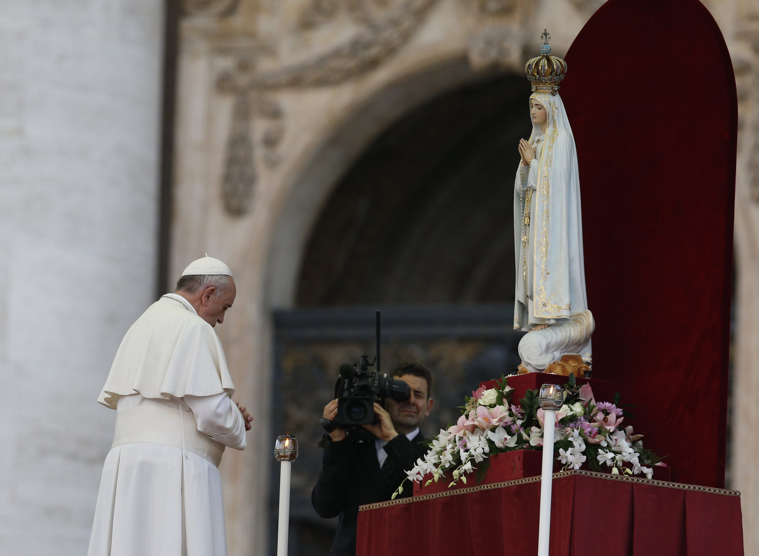 Pope Francis prays in front of the original statue of Our Lady of Fatima during a Marian vigil in St. Peter's Square at the Vatican in this Oct. 12, 2013, file photo. The pope has invited "every community and every believer" to join him in consecrating and entrusting Russia and Ukraine to Mary March 25, 2022. (CNS photo/Paul Haring)