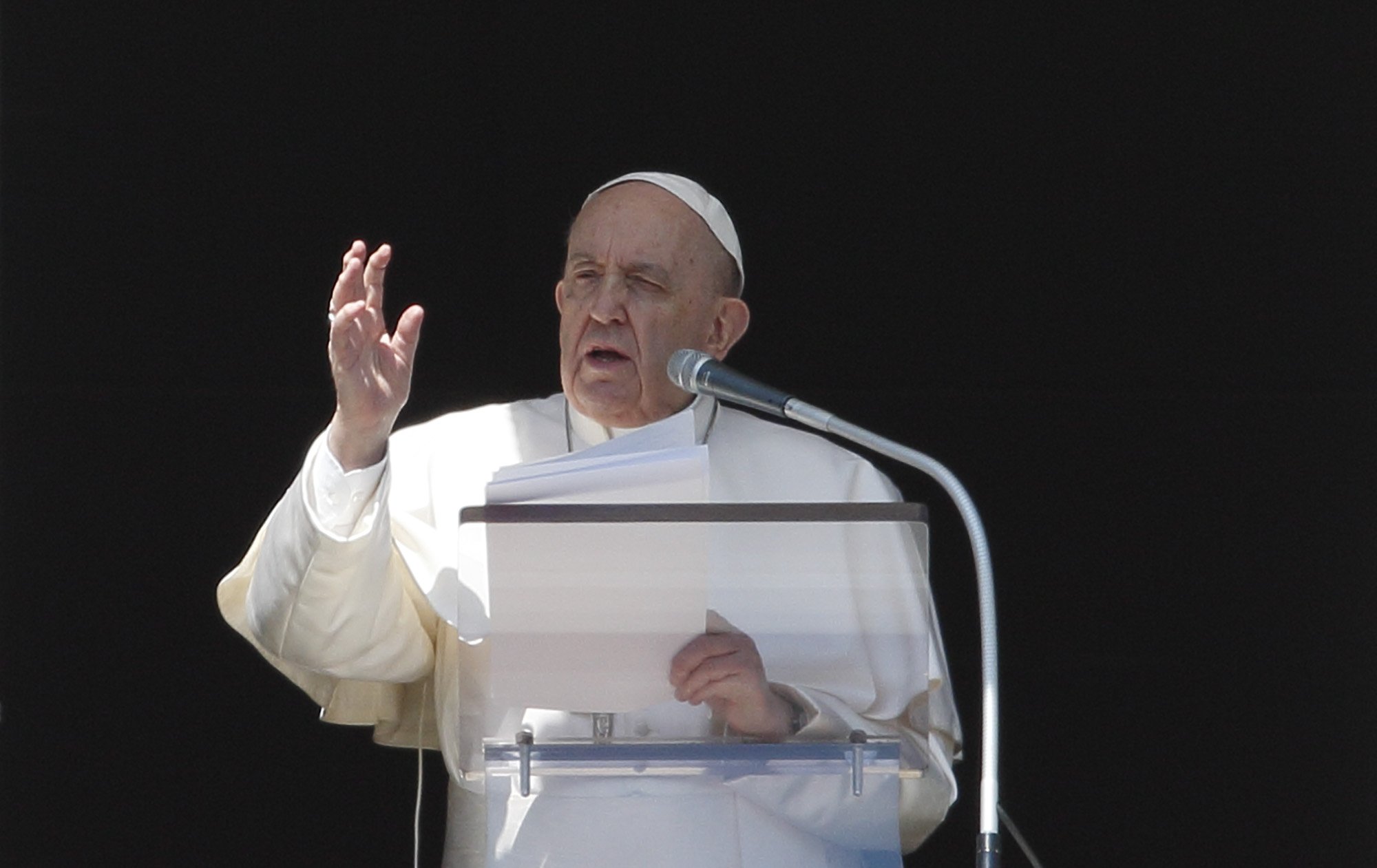 Pope Francis gives his blessing after leading the Angelus from the window of his studio overlooking St. Peter's Square at the Vatican March 13, 2022. Appealing again for peace in Ukraine, Pope Francis said those who support violence profane the name of God. (CNS photo/Paul Haring)