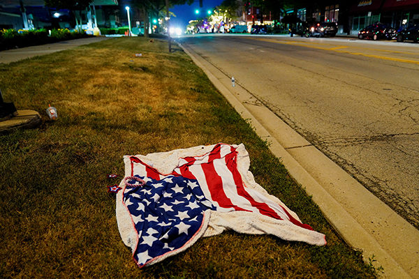 An American flag blanket is seen abandoned along the parade route after a mass shooting in the Chicago suburb of Highland Park, Ill., July 4, 2022. (CNS photo/Cheney Orr, Reuters)