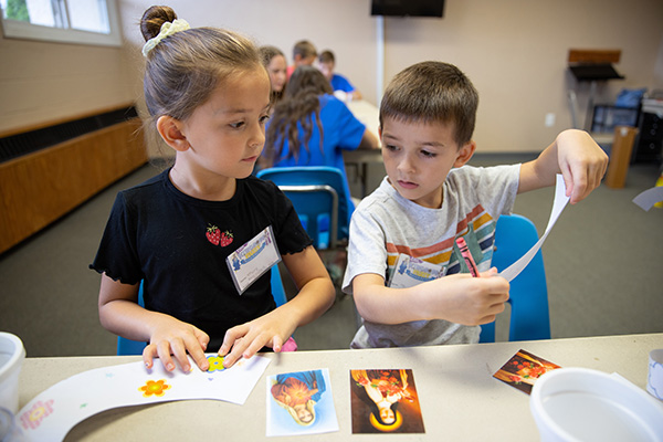 Mary Bell, 7, left, and her brother James, 5, craft plant pots with an illustration of the Blessed Mother, at Mary, Mother of Mercy Parish in Glassboro, NJ on Tuesday, July 26, 2022.