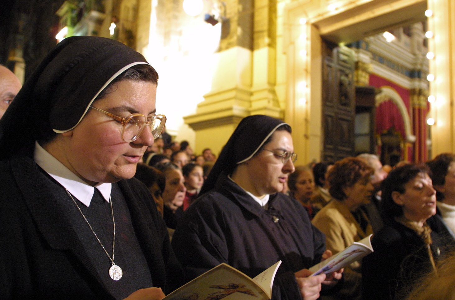 Nuns sing hymns after a 370-year-old crucifix is carried out of the Church of St. Mary of Jesus in Valletta April 11. The procession was held in connection with Pope John Paul II's upcoming visit to the island and his beatification of Father George Preca. (CNS photo from Reuters) (April 24, 2001) See POPE-PREVIEW April 24, 2001.
