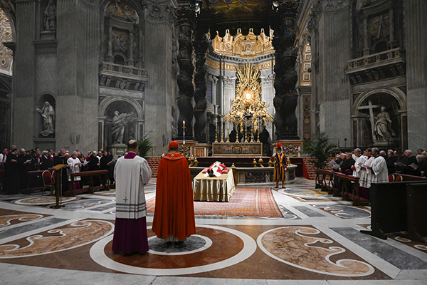 Cardinal Mauro Gambetti, archpriest of St. Peter's Basilica, leads the Rite of Reception at the body of Pope Benedict XVI after its transfer into St. Peter's Basilica in the early morning at the Vatican Jan. 2, 2023. (CNS photo/Vatican Media)