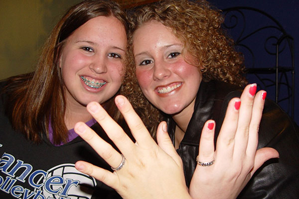 Teenagers Katherine Zwirner, left, and Bridgit DeCarlo, from the Detroit area, show off chastity rings they received at the "Silver Ring Thing" event in late March. The rings illustrate their commitment to abstain from sex until marriage. The interdenominational event drew more than 1,000 people, including both parents and youths. More than 470 youths made a pledge to chastity. (CNS photo by Michelle Samartino, Michigan Catholic) (April 15, 2005) See CHASTITY April 15, 2005.