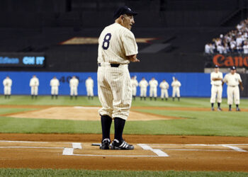 Former New York Yankee Yogi Berra stands at home plate before the final regular season MLB American League baseball game at Yankee Stadium in New York, in this file photo taken September 21, 2008. Berra, a Hall of Fame catcher for the New York Yankees whose mangled syntax made him one of the sports world's most beloved and frequently quoted figures, died on Tuesday at the age of 90, Major League Baseball said.  REUTERS/Mike Segar/Files