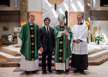 Bishop Dennis Sullivan takes a photo with the Diocese of Camden’s newest seminarian, Benjamin Suarez III, after Mass on Aug. 13 in Saint Andrew the Apostle Church, Gibbsboro. Also pictured, from left, Father Adam Cichoski, diocesan director of vocations, and Father Joshua Nevitt, associate director of vocations. (Photo by John Kalitz)