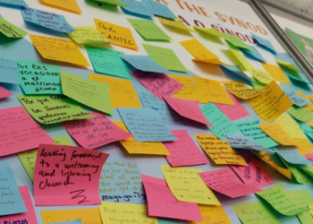 Dozens of Post-it Notes with prayers and requests from young people are seen on the wall at the Synod of Bishops' booth in a park in Lisbon, Portugal, during World Youth Day Aug. 1-6, 2023. (OSV News photo/Courtesy of the Synod Secretariat)