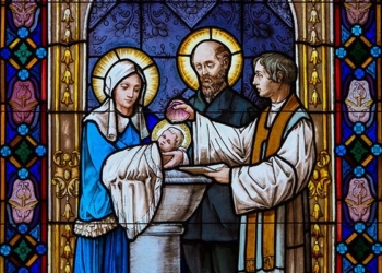 A stained glass window inside St. Thérèse Chapel at Holy Hill in Hubertus, Wis., depicts the baptism of St. Thérèse of Lisieux at the Church of Our Lady of the Assumption in Alencon, France.  (OSV News photo/Sam Lucero)