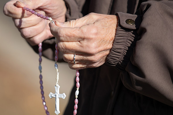 Bridgid Kernan, of the St. Teresa of Calcutta Parish, recites the rosary outside of the Cherry Hill Women's Center on Wednesday, December 1, 2021.