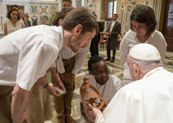 Pope Francis accepts a gift from members of the Chemin Neuf lay movement at the end of an audience May 16, 2022, in the Clementine Hall of the Apostolic Palace at the Vatican. (CNS photo/Vatican Media)