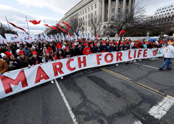 Pro-life demonstrators carry a banner past the U.S. Supreme Court during the annual March for Life in Washington Jan. 20, 2023, for the first time since the high court overturned its 1973 Roe v. Wade abortion decision June 24, 2022. The March for Life's theme for the 2024 event will be "Pro-Life: With Every Woman, For Every Child," the group's president announced Nov. 14, 2023. (OSV News photo/Jonathan Ernst, Reuters)
