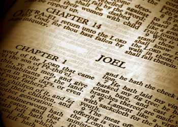 Bible Series. close up detail of antique holy bible open to the book of joel in the old testament finished in sepia