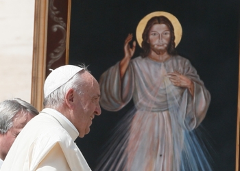 Pope Francis walks near an image of Jesus of Divine Mercy after celebrating a Mass marking the feast of Divine Mercy in St. Peter's Square at the Vatican April 8, 2018. Masses for Divine Mercy Sunday, celebrated on the Sunday after Easter, are expected to be livestreamed in Catholic churches throughout the United States amid the coronavirus pandemic. (CNS photo/Paul Haring) See DIVINE-MERCY-MASS-BASILICA April 16, 2020.
