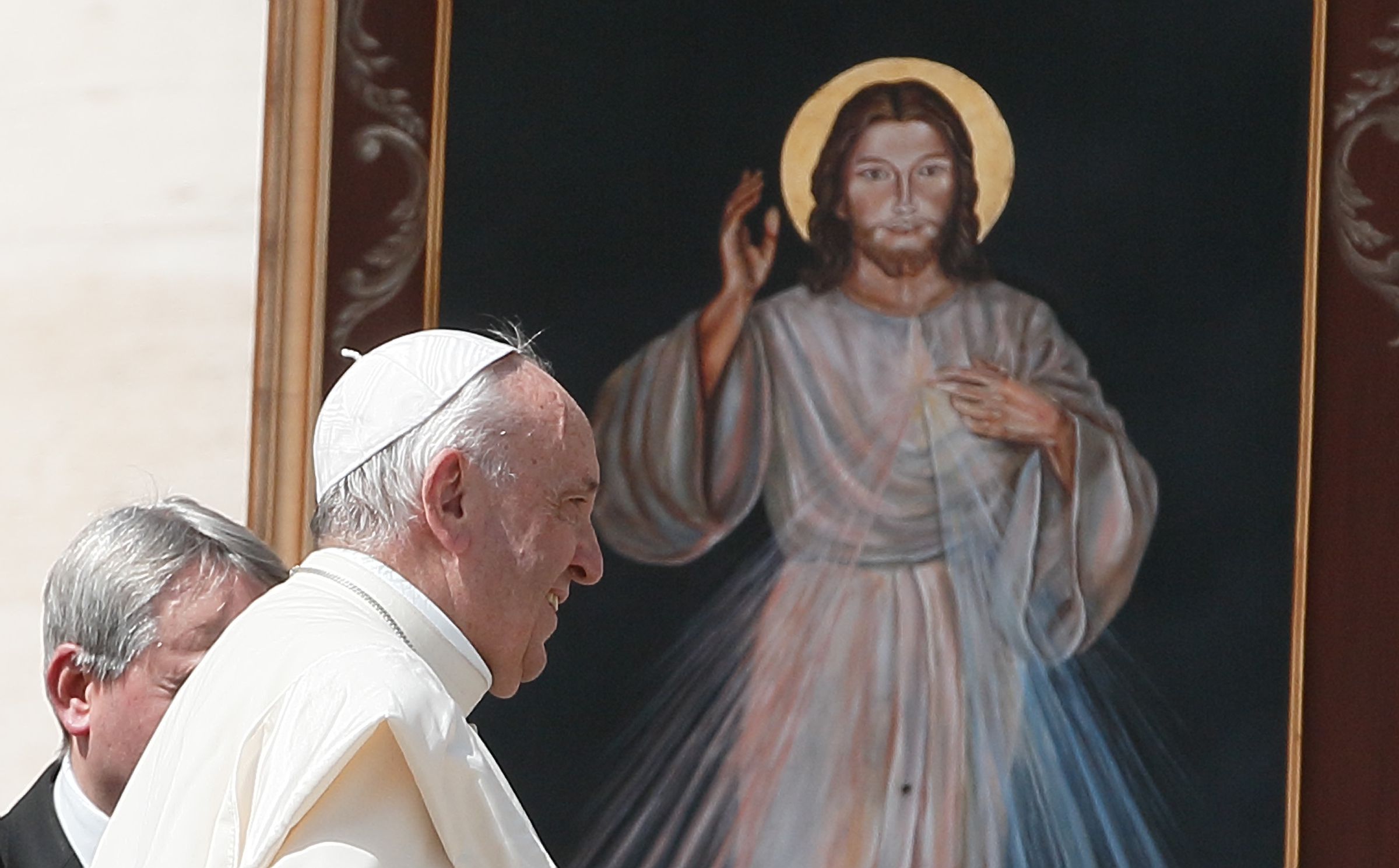 Pope Francis walks near an image of Jesus of Divine Mercy after celebrating a Mass marking the feast of Divine Mercy in St. Peter's Square at the Vatican April 8, 2018. Masses for Divine Mercy Sunday, celebrated on the Sunday after Easter, are expected to be livestreamed in Catholic churches throughout the United States amid the coronavirus pandemic. (CNS photo/Paul Haring) See DIVINE-MERCY-MASS-BASILICA April 16, 2020.