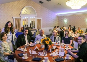 Jennifer Lon, associate director of the Office of Development for the Diocese of Camden, visits with Father Robert Sinatra, pastor of Saint Padre Pio, Vineland, and parishioners during the South Jersey Catholic Ministries Appeal Appreciation Dinner on June 13 in Hammonton. Photos by Jennifer Mauro