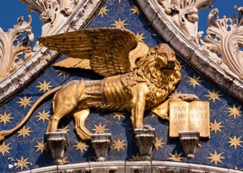 One of the large Golden Lions of St Mark in St Marks Square, Venice, Italy