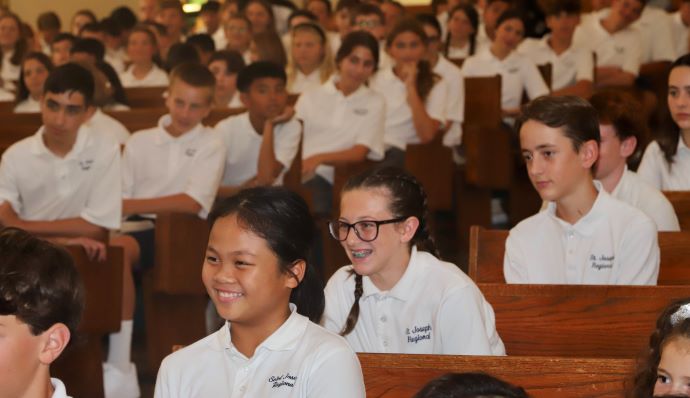 Photo by Mike Walsh
Students grin during Bishop Dennis Sullivan’s homily as the first week of classes gets underway last year at Saint Joseph Regional School, Somers Point.