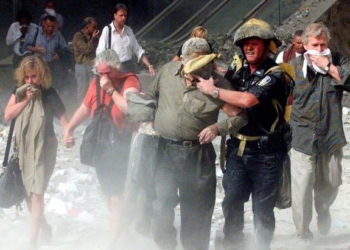 People covered in ash walk away from the World Trade Center in New York City on Sept. 11, 2001. (OSV News photo/Shannon Stapleton, Reuters)
