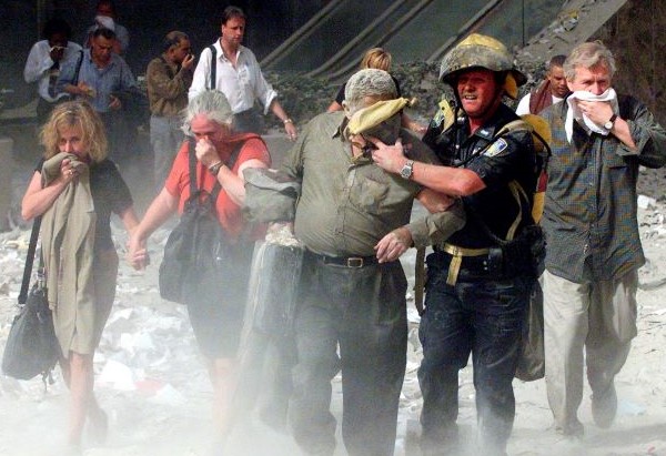 People covered in ash walk away from the World Trade Center in New York City on Sept. 11, 2001. (OSV News photo/Shannon Stapleton, Reuters)