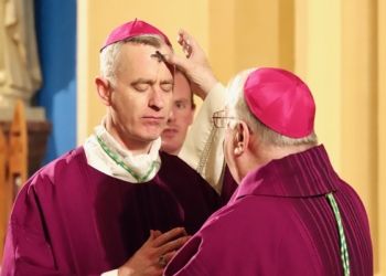 Bishop Sullivan makes the sign of the cross with ashes on Coadjutor Bishop Williams' forehead. (Photo - Mike Walsh)