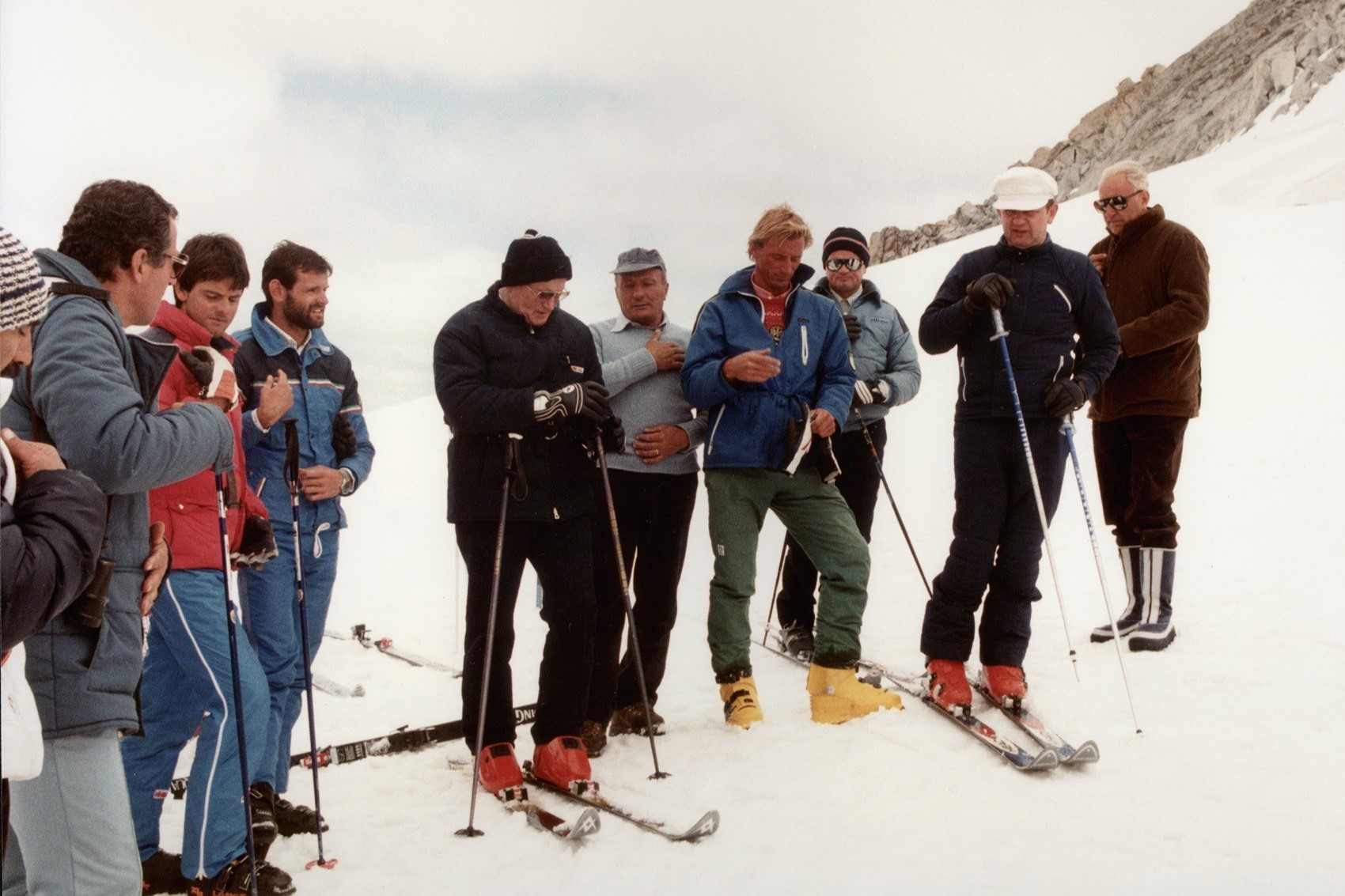 Pope John Paul II (center, in red boots) prays with a group of skiers before heading down a slope in this 1984 file photo. The pontiff, who enjoyed skiing in his native Poland before his election, was able to slip away to ski only a few times as he led the worldwide church. (OSV News photo/Arturo Mari, Vatican)