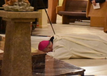 Bishop Dennis Sullivan lays prostrate at the beginning of a prayer service for clergy abuse survivors and reparations for the sins of the Church in Saint Agnes Church, Our Lady of Hope Parish, Blackwood in September 2018. (Photo by James A. McBride)