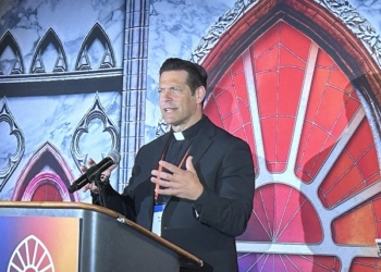 Father Mike Schmitz, director of Youth and Young Adult Ministry for the Diocese of Duluth, as well as the chaplain for the Newman Center at the University of Minnesota-Duluth, speaks to media at the National Eucharistic Congress in Indianapolis July 18. Father Schmitz is also the host of the popular Ascension podcasts “Bible in a Year” and “Catechism in a Year.” (OSV News photo/Gretchen R. Crowe)