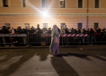 A religious sister walks past a line of people waiting to pay their respects to Pope Francis, lying in state in St. Peter's Basilica at the Vatican April 23, 2025. Public viewing was to continue until April 25, the night before the late pope's funeral. (CNS photo/Pablo Esparza)