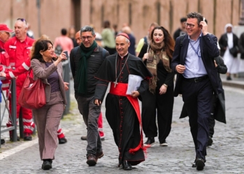 Cardinal Jean-Paul Vesco of Algiers, Algeria, walks with members of the press toward the Petriano entrance at the Vatican April 24, 2025, to attend a general congregation meeting in the New Synod Hall ahead of the funeral Mass for Pope Francis. (CNS photo/Lola Gomez)