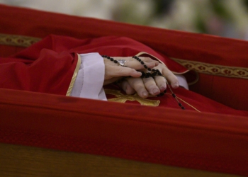 The hands of Pope Francis, holding a rosary, are seen as he lies at rest in his coffin in the chapel of his residence, the Domus Sanctae Marthae, at the Vatican April 21, 2025. (CNS photo/Vatican Media)