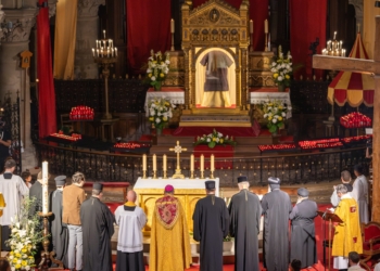 Bishop Benoît Bertrand of Pontoise, France, who holds the official title of the "Guardian of the Holy Tunic," prays in front of the Holy Tunic of Argenteuil, with representatives of Eastern Churches, on April 21, 2025, in the Basilica of St. Denis in Argenteuil. Until May 11, pilgrims will be able to venerate what is believed to be the Seamless Robe of Christ that he wore before his passion. (OSV News photo/courtesy Diocese of Pontoise)