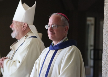 Prior to his episcopal ordination as auxiliary bishop of the Archdiocese of Military Services, USA, Father Gregg Caggianelli takes a moment before processing into St. Vincent Chapel on the campus of St. Vincent de Paul Regional Seminary in Boynton Beach, Fla., with clergy and bishops from across Florida and the nation May 9, 2025. At left is Miami Archbishop Thomas G. Wenski. (OSV News photo/Jean Gonzalez, Florida Catholic)