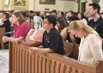 in the National Eucharistic Pilgrimage kneel in prayer on May 18, 2025, during a Mass at St. John the Evangelist Church in Indianapolis. The pilgrimage, which will conclude on June 22 in Los Angeles, will travel through 10 states and 20 dioceses in its St. Katherine Drexel Route. (OSV News photo/Sean Gallagher, The Criterion)