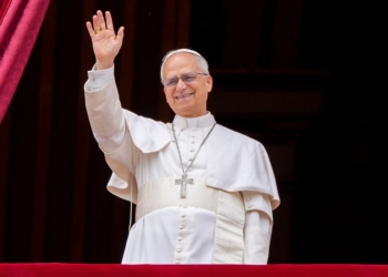 Pope Leo XIV waves to the crowd from the central balcony of St. Peter's Basilica at the Vatican as he leads, for the first time, the midday recitation of the "Regina Coeli" prayer May 11, 2025. (CNS photo/Lola Gomez)