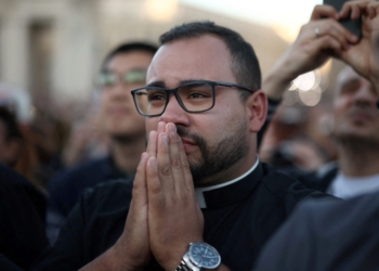 A man religious reacts as Cardinal Robert Francis Prevost, who has chosen the papal name Leo XIV, appears on the central balcony of St. Peter's Basilica at the Vatican May 8, 2025, following his election during the conclave. He is the first American pope in history. (OSV News photo/Marko Djurica, Reuters)