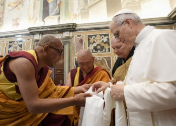 Pope Leo XIV greets Buddhist monks who present him with gifts during a meeting with religious leaders at the Vatican May 19, 2025. The leaders were in Rome for the pope’s inauguration Mass. (CNS photo/Vatican Media)