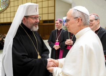 Pope Leo XIV greets Sviatoslav Shevchuk, Major Archbishop of Kyiv-Galicia, during a meeting with participants in the Jubilee of the Eastern Churches in the Paul VI Audience Hall at the Vatican as he tries on a traditional shawl May 14, 2025. (CNS photo/Vatican Media)