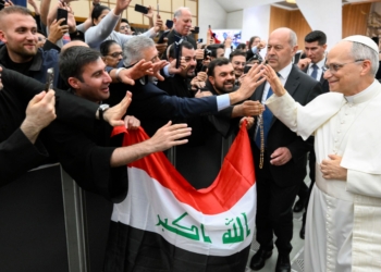Pope Leo XIV greets participants holding an Iraqi flag as he walks through the Paul VI Audience Hall at the Vatican during the Jubilee of the Eastern Churches May 14, 2025. (CNS photo/Lola Gomez)