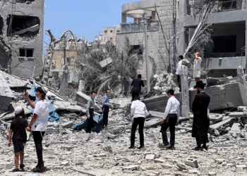 Ultra Orthodox jews look at an impacted site in Tel Aviv, Israel, June 16, 2025, following a missile attack from Iran. Iran fired a new wave of missile attacks on Israel early June 16, killing several people, while Israel warned residents of part of Tehran to evacuate ahead of new strikes.  (OSV News photo/Miro Maman, Reuters)