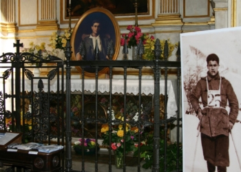 Images of Blessed Pier Giorgio Frassati appear beside and on his tomb at St. John the Baptist Cathedral in Turin, Italy, in this file photo from February 2006. (CNS file photo/Carol Glatz)