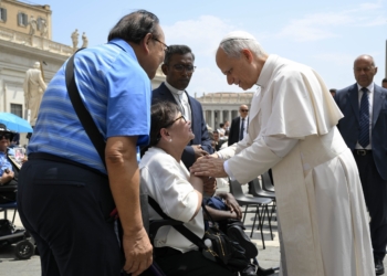 Pope Leo XIV blesses a child as he arrives in St. Peter's Square on the popemobile for his general audience June 18, 2025. (CNS photo/Justin McLellan)