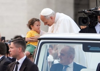 Pope Leo XIV greets a child from the popemobile as he prepares to lead a Pentecost prayer vigil in St. Peter's Square at the Vatican June 7, 2025, with participants in the Jubilee of Ecclesial Movements, Associations and New Communities. (CNS photo/Lola Gomez)