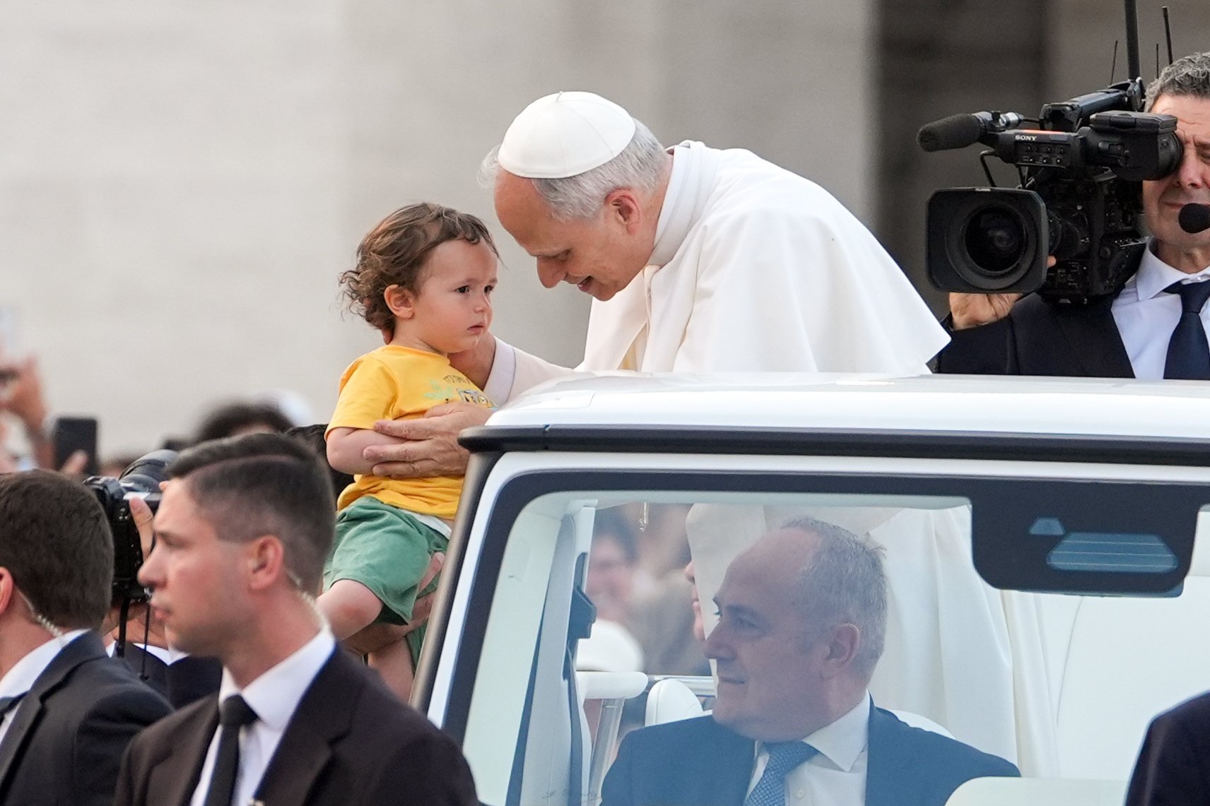 Pope Leo XIV greets a child from the popemobile as he prepares to lead a Pentecost prayer vigil in St. Peter's Square at the Vatican June 7, 2025, with participants in the Jubilee of Ecclesial Movements, Associations and New Communities. (CNS photo/Lola Gomez)