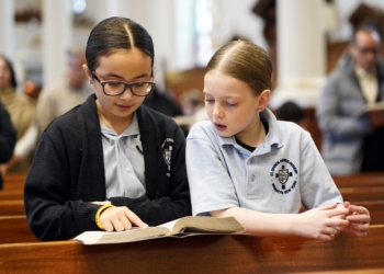 Aria Valvano, left, and Milania Phillips, third graders at St. Ephrem Catholic Academy in the Dyker Heights section of Brooklyn, N.Y., sing during a Mass marking the opening of national Catholic Schools Week at St. Ephrem Church Jan. 26, 2025. (OSV News photo/Gregory A. Shemitz)